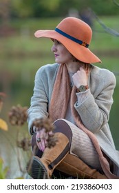 Beautiful Woman Portrait. Attractive Woman Sitting By The Lake. Fashion Shoot. Selective Focus
