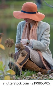 Beautiful Woman Portrait. Attractive Woman Sitting By The Lake. Fashion Shoot. Selective Focus
