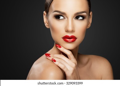 Beautiful woman portrait, beauty on dark background, red nails