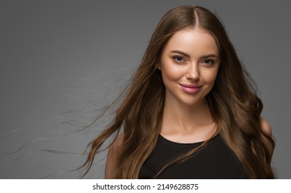 Beautiful woman portrait curly long hair beauty natural black dress gray background - Shutterstock ID 2149628875
