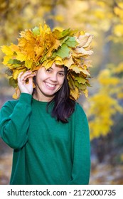 beautiful woman portrait with maple leaf wreath on the head autumn season