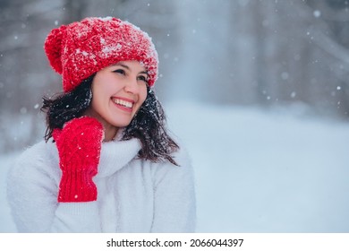 beautiful woman portrait outdoors in snowed forest copy space