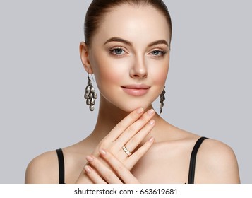 Beautiful Woman Portrait with Perfect makeup Hairstyle. Fashion Model jewelry over gray background. Studio shot. - Shutterstock ID 663619681