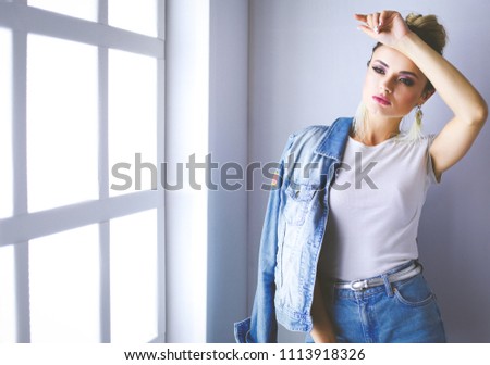 Beautiful woman portrait standing near window.Isolated on white background