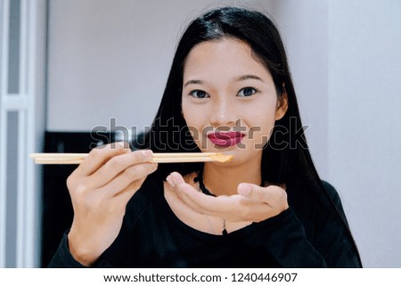 Beautiful woman posing - eating, looking at camera, smiling face, showing