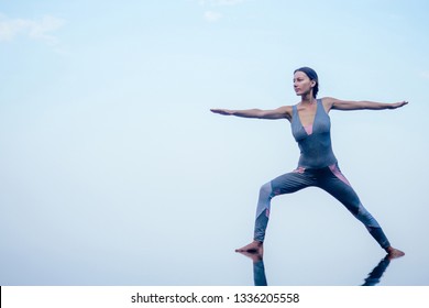 Beautiful woman practice yoga pose on the infinity pool above the mountain peak in the morning in front of beautiful nature views in india goa wildernest nature resorte .romance sunrise in mountains - Shutterstock ID 1336205558