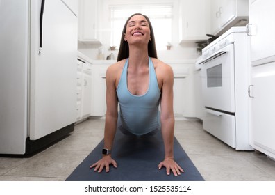 Beautiful Woman Practicing Yoga, Exercising In Small Home Room Kitchen, Tiny Home, Cramped Apartment