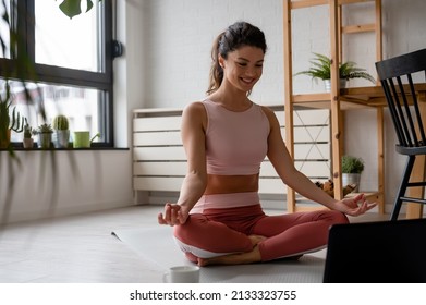 Beautiful Woman Practicing Yoga At Home, Trying To Get In Shape After Child Birth. Fitness Routines After 40