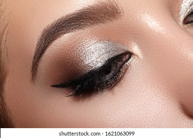 Beautiful Woman with Professional Makeup. Closeup Macro of Woman Face with Cat-Eye Make-up. Fashion Celebrate Makeup, Perfect Eyebrows, Glowy Clean Skin, perfect Shapes of Brows. Shiny Shimmer - Powered by Shutterstock