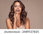 Beautiful woman in profile  with long  and   shiny wavy  hair .  Beauty  model girl with curly hairstyle .  Presenting your product. Expressive facial expressions