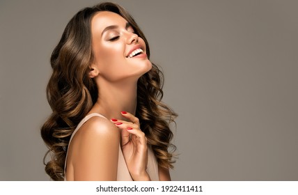 Beautiful woman in profile  with long  and   shiny wavy  hair .  Beauty  model girl with curly hairstyle . - Shutterstock ID 1922411411