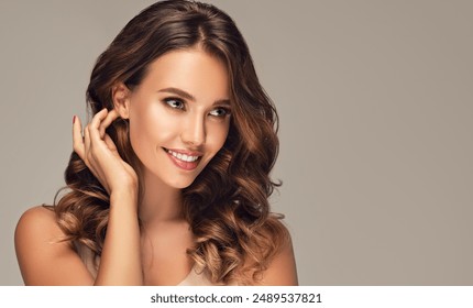 Beautiful woman in profile  with long  and   shiny wavy  hair .  Beauty  model girl with curly hairstyle .  Presenting your product. Expressive facial expressions