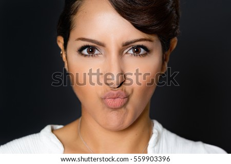 Beautiful woman with pucker lips facial expression
