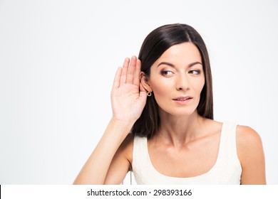 Beautiful Woman Puts A Hand To The Ear To Hear Better Isolated On A White Background