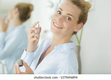 beautiful woman putting on a perfume