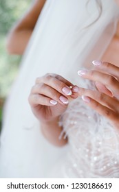 Beautiful woman putting on wedding golden ring. Close up womans hands - Shutterstock ID 1230186619