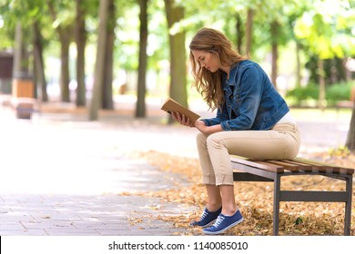 Beautiful woman read an old book  in the park