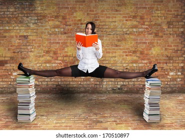 Beautiful Woman Is Reading A Book And Does A Balancing Act