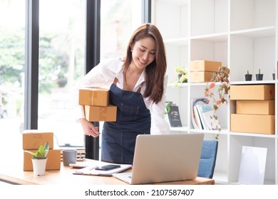 Beautiful Woman Receiving Her Package From An Online Shopping Store, Unboxing, Unpacking Goods.