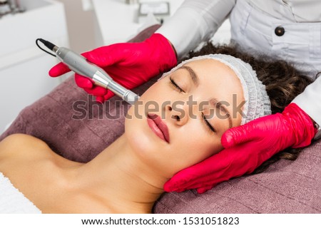 Beautiful woman receiving microneedling rejuvenation treatment. Mesotherapy. 