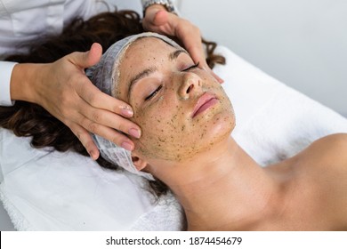 Beautiful Woman Receiving Natural Green Peel Facial Mask With Rejuvenating Effects In Spa Beauty Salon.