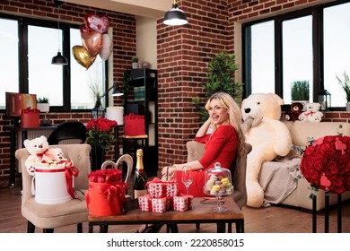 Beautiful Woman Receiving Valentines Day Expensive Gifts In Living Room, Attractive Blonde Girlfriend With Luxury Present Boxes, Soft Toy, Red Roses Bouquets. February 14 Romantic Surprises