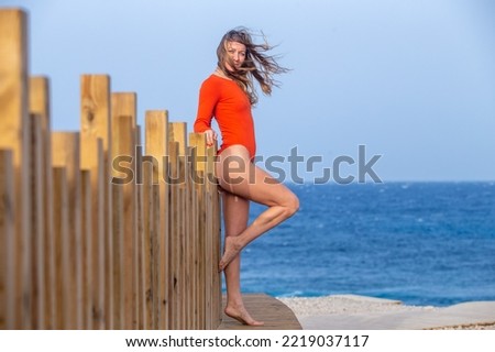 Beautiful woman in red bikini on beach