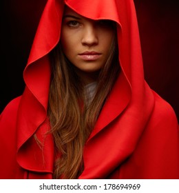 Beautiful Woman With Red Cloak In Studio