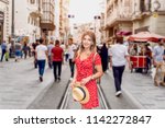 Beautiful woman in red dress stands at Istiklal street,a popular location in Boyoglu district,Istanbul,Turkey