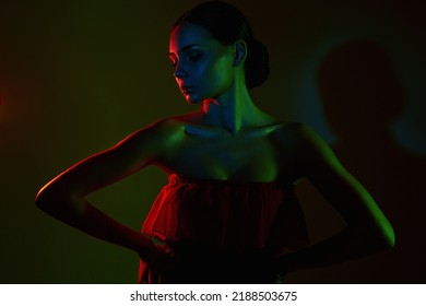 Beautiful Woman In Red And Green Color Bright Lights. Silhouette Of Pretty Girl In Red Dress