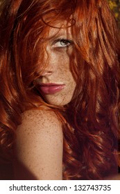 Beautiful Woman With Red Hair And Freckles Outdoors