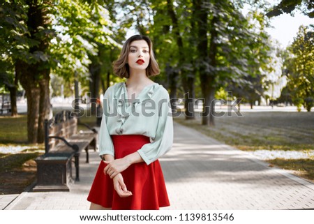    beautiful woman in a red skirt                            