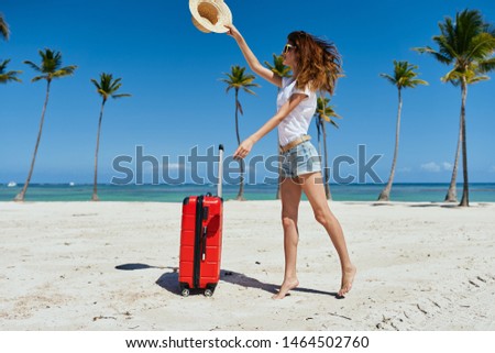 beautiful woman with red suitcase beach tropics exotic destination sea voyage