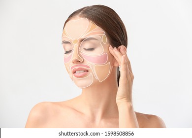 Beautiful Woman With Reflexology Massage Areas On Her Face Against White Background