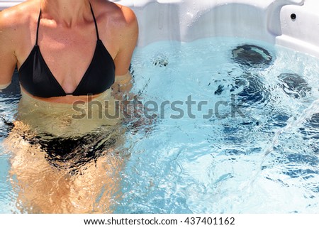 Beautiful woman relaxing in hot tub.