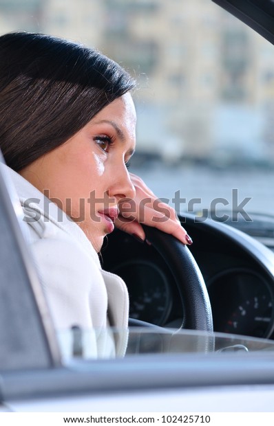 beautiful woman is resting in a\
car