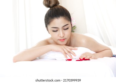 Beautiful woman is resting on spa bed for massage therapy in spa shop. Young girl relaxing for alleviate stress in the body at beauty salon.

 - Shutterstock ID 2170399939