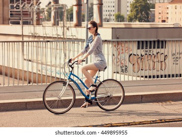 Beautiful Woman Riding Bike In The City In Summer