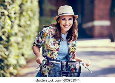 Beautiful Woman Riding Bike In The City