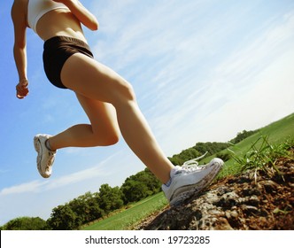 Beautiful Woman Runner In Front Of Blue Sky, Low Angle.