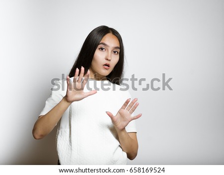 beautiful woman scared, isolated on a gray background