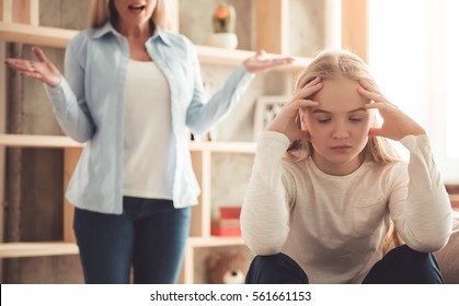 Beautiful woman is scolding her teenage daughter, girl is ignoring her mom
