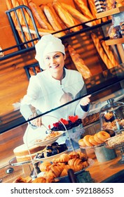 Beautiful Woman Selling Fresh Pastry And Loaves In Bread Section And Smiling