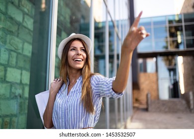 Beautiful woman with shopping bag. Sale, shopping, tourism and happy people concept - Shutterstock ID 1453532507