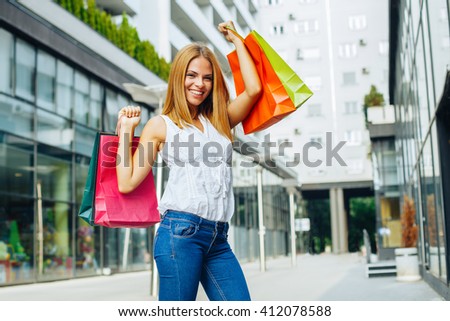 Beautiful woman with shopping bags in the ctiy
