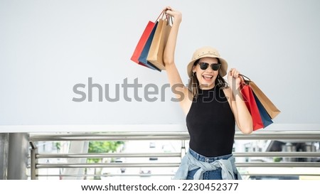 Beautiful Woman in shopping seasons. Happy young female with shopping bags enjoying to buy fasions. Consumerism, shopping, lifestyle concept.Spending shopping mall with paper bag.shopaholic consumer. Сток-фото © 