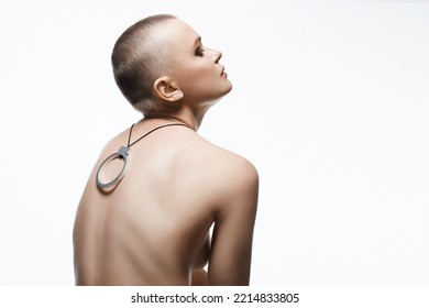 Beautiful Woman With Short Haircut. Back Of Naked Bald Girl With Necklace