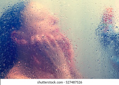 Beautiful Woman In The Shower Behind Glass With Drops