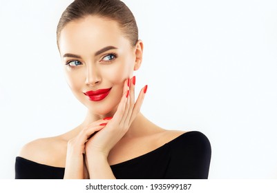 Beautiful woman showing red  manicure nails . Makeup, beauty and cosmetics. Famele beauty face care and treatment. Expressive facial expressions