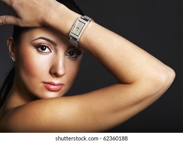 Beautiful woman with silver wristwatch